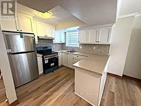 Toronto (Bendale) apartment for rent - A kitchen with a stainless steel refrigerator, a dishwasher, and wooden flooring.