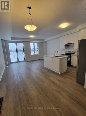 Markham (Middlefield) townhouse for rent - A kitchen with a white counter and a brown floor.