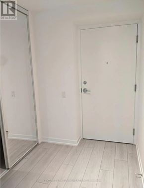 Vaughan (Vaughan Corporate Centre) condo for rent - A white door in a room with a realtor logo on the wall.