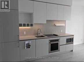 Vaughan (Vaughan Corporate Centre) condo for rent - A modern kitchen with a sink and a stove top oven.