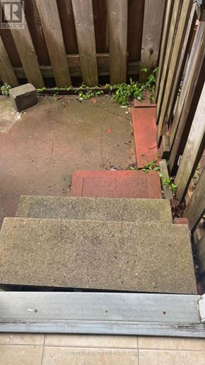 Markham (Middlefield) apartment for rent - A set of stairs with a metal handrail and a wooden fence.