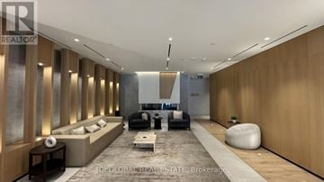 Toronto (Regent Park) condo for rent - A modern living room with a long couch and a coffee table.