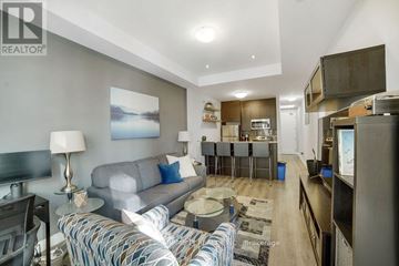 Hamilton (Central) condo for rent - A living room with a grey couch and a coffee table.