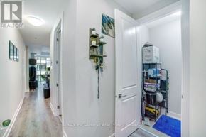 Hamilton (Central) condo for rent - A hallway with a broom and a mop in a closet.