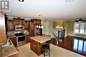 South River apartment for rent - A kitchen with a center island and a dining area.
