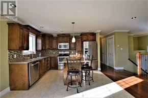 South River apartment for rent - A kitchen with wooden cabinets and a granite countertop.