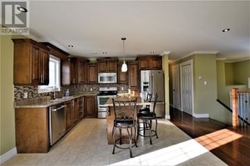 South River apartment for rent - A kitchen with wooden cabinets and a granite countertop.