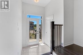 Brantford townhouse for rent - A white interior room with a door leading to a balcony.