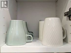 Hamilton (Crown Point) apartment for rent - Two mugs, one light blue and one white, are sitting on a shelf.