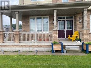Hamilton (Binbrook) apartment for rent - A house with a purple door and a yellow chair on the porch.