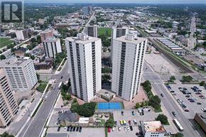 London East (East K) condo for rent - A cityscape with a large building in the center and a pool in the foreground.