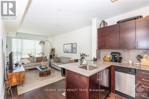 Ottawa condo for rent - A modern kitchen with dark wood cabinets and a central island.