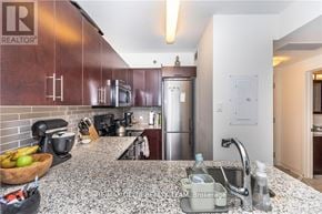 Ottawa condo for rent - A kitchen with a granite countertop and stainless steel appliances.