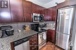 Ottawa condo for rent - A kitchen with brown cabinets and a stainless steel refrigerator.
