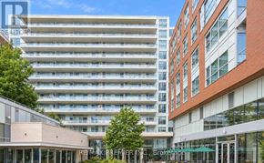 Toronto (High Park North) condo for rent - A modern building with a glass facade is in the foreground.