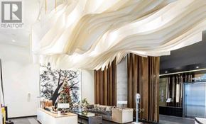 Toronto (High Park North) condo for rent - A modern interior space with a large, curved wooden structure overhead.