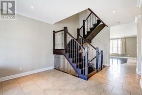 Niagara Falls (Forestview) apartment for rent - A spacious room with a staircase and tiled flooring.
