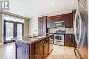 Niagara Falls (Forestview) apartment for rent - A modern kitchen with dark wood cabinets and stainless steel appliances.