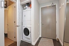 Toronto (Niagara) condo for rent - A white washer and dryer are in a small laundry room.