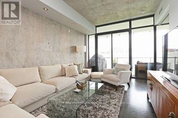 Toronto (Niagara) condo for rent - A living room with a glass table and a couch.