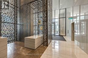 Toronto (Waterfront Communities) condo for rent - A hallway with a glass partition and a wooden bench.