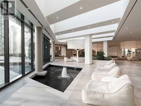 Toronto (Waterfront Communities) condo for rent - A modern living room with a pool table and a waterfall.