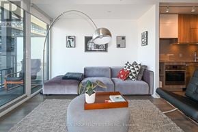 Toronto (Waterfront Communities) condo for rent - A living room with a grey couch and a coffee table.