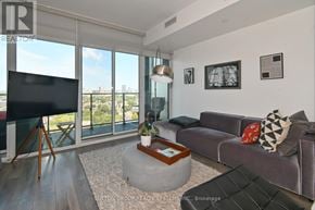 Toronto (Waterfront Communities) condo for rent - A living room with a flat screen TV and a large window.