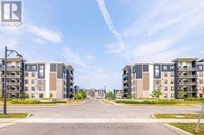 Milton (Be Beaty) condo for rent - A street view of a residential area with apartment buildings and a clear blue sky.