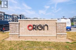 Milton (Be Beaty) condo for rent - A sign with the word "ORIGIN" in red letters is mounted on a brick wall.