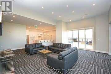 Milton (Be Beaty) condo for rent - A living room with a grey carpet and black leather sofas.