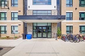 Milton (Be Beaty) condo for rent - The front of a building with a sign that says "REALTOR" on the left side.