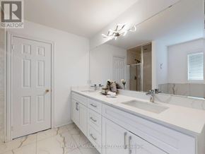 Brampton (Bram East) apartment for rent - A white bathroom with a sink, mirror, and a door.