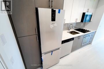 Hamilton (Kirkendall) house for rent - A modern kitchen with a refrigerator and sink.
