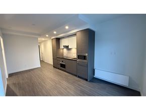 Surrey apartment for rent - A kitchen with a wooden floor and white walls.