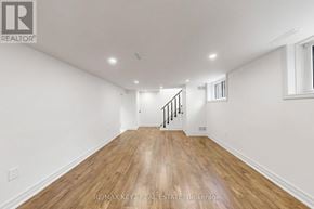 Whitby (Downtown Whitby) apartment for rent - A spacious room with wooden flooring and white walls.