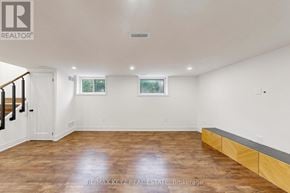 Whitby (Downtown Whitby) apartment for rent - A spacious room with wooden flooring and white walls.