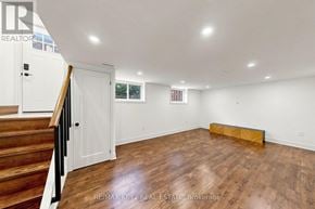 Whitby (Downtown Whitby) apartment for rent - A room with wooden flooring and white walls, with a staircase on the left side.