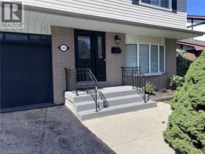 Hamilton apartment for rent - A house with a black door and a sign that says REALTOR.