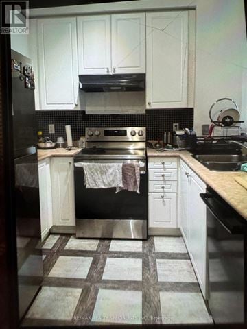 Mississauga (City Centre) condo for rent - A kitchen with black appliances and white cabinets.
