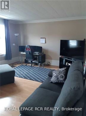 Caledon (Bolton West) multi-family for rent - A living room with a couch, a television, and a desk with a computer.