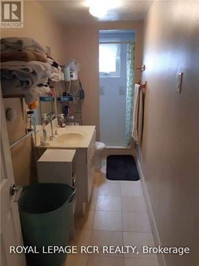 Caledon (Bolton West) multi-family for rent - A bathroom with a sink, toilet, and a trash can.