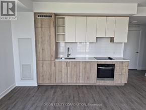 Vaughan (Vaughan Corporate Centre) condo for rent - A kitchen with wooden cabinets and a white backsplash.