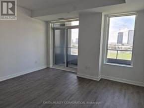 Vaughan (Vaughan Corporate Centre) condo for rent - A room with a sliding glass door and a window overlooking a cityscape.