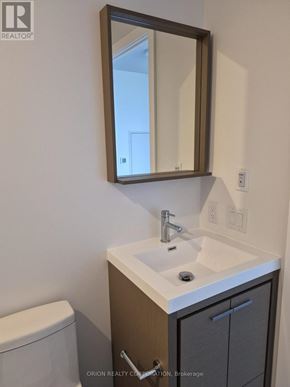 Vaughan (Vaughan Corporate Centre) condo for rent - A bathroom with a sink, toilet and mirror.