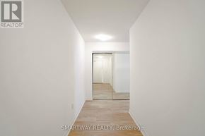 Toronto (Alderwood) condo for rent - A hallway with a door at the end.