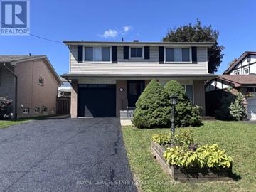 Hamilton (Gilbert) apartment for rent - A house with a garage and a driveway in front of it.