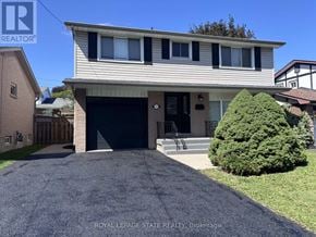 Hamilton (Gilbert) apartment for rent - A house with a garage and a driveway in front of it.