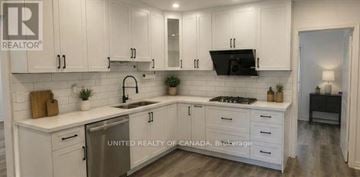 Richmond Hill (North Richvale) apartment for rent - A kitchen with white cabinets and a sink.