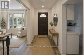 Richmond Hill (North Richvale) apartment for rent - A brokerage image of a well-lit hallway with a bench, a door, and a mirror.